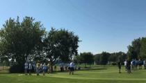 Ďaleký pohľad na golfové ihrisko a skupinu osôb